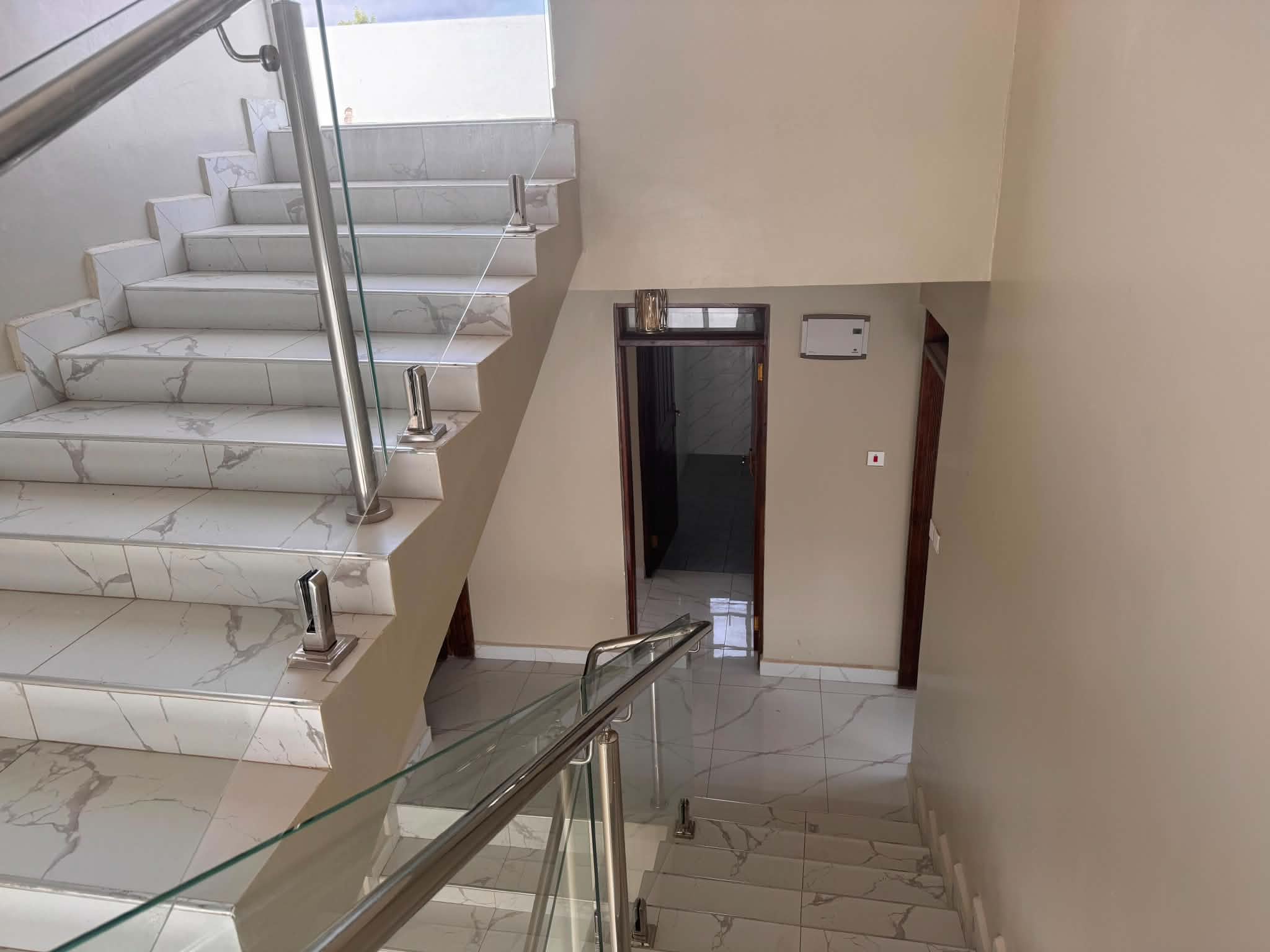 Tiled staircase with glass balustrade