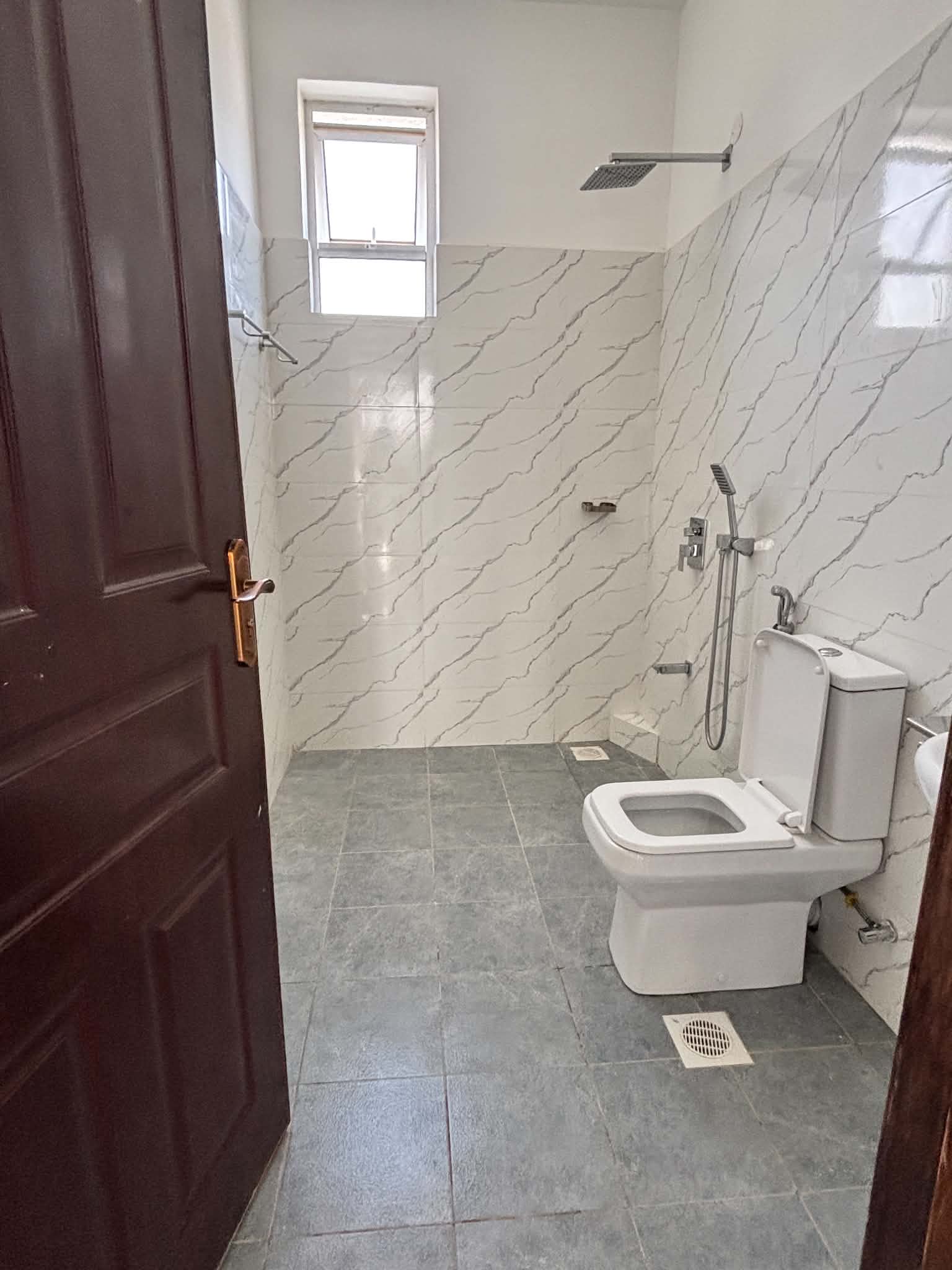Tiled bathroom with walk-in shower