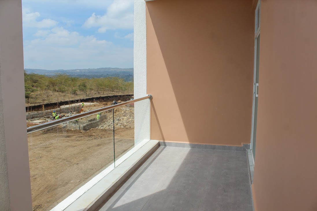 Balcony overlooking open land and blue skies