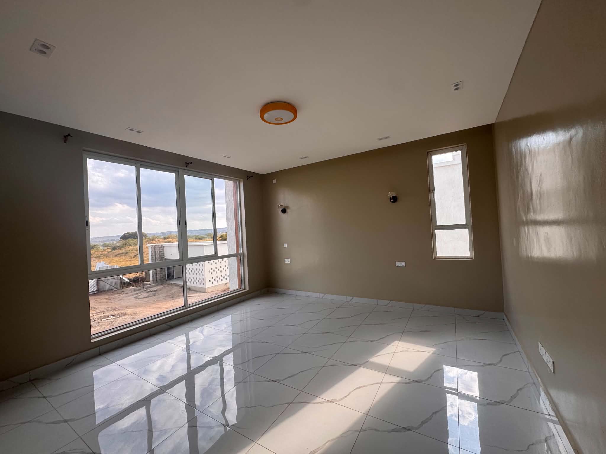 Bright room with a large window and tiled floor