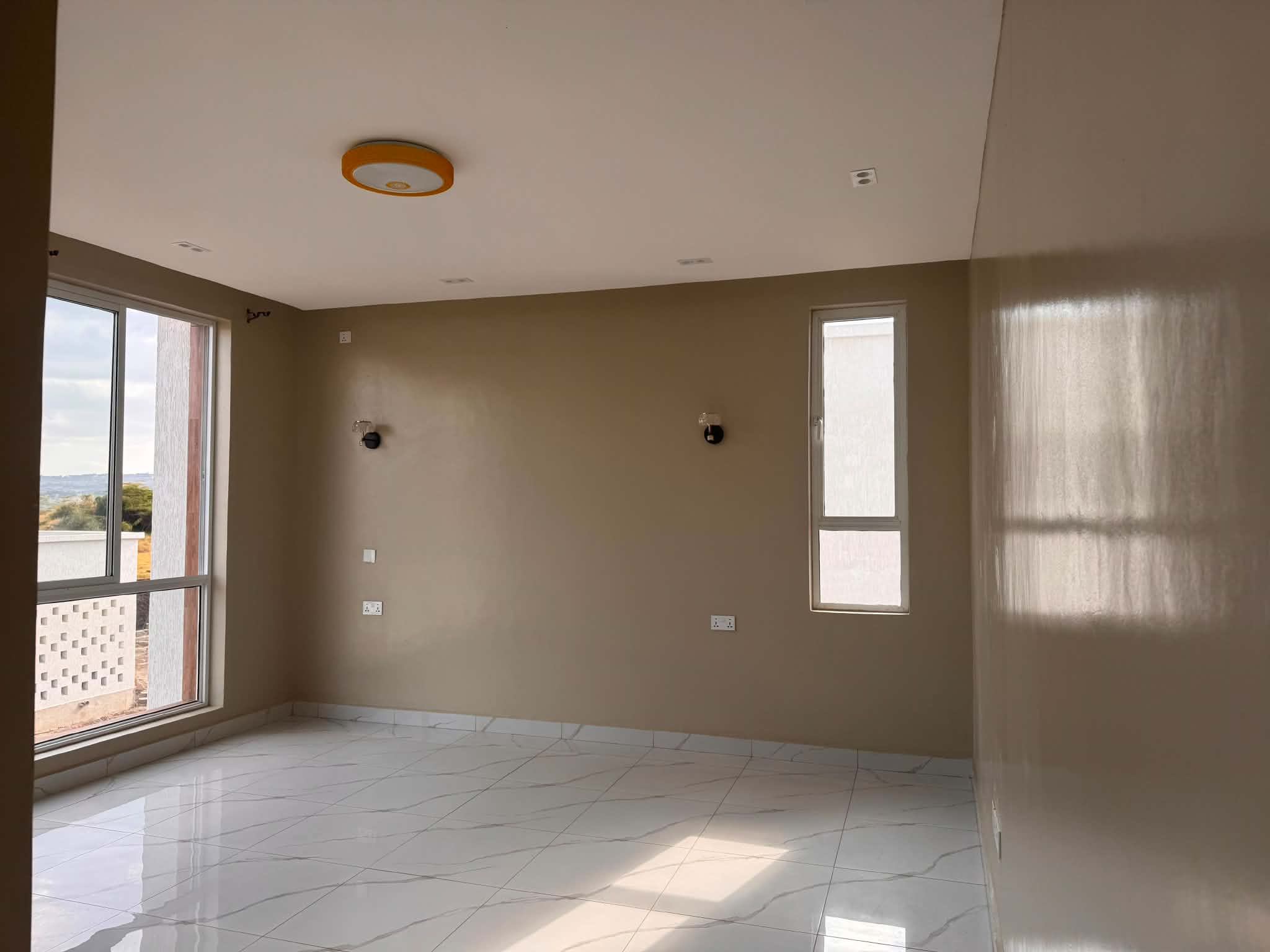 Room with two windows and a polished tiled floor