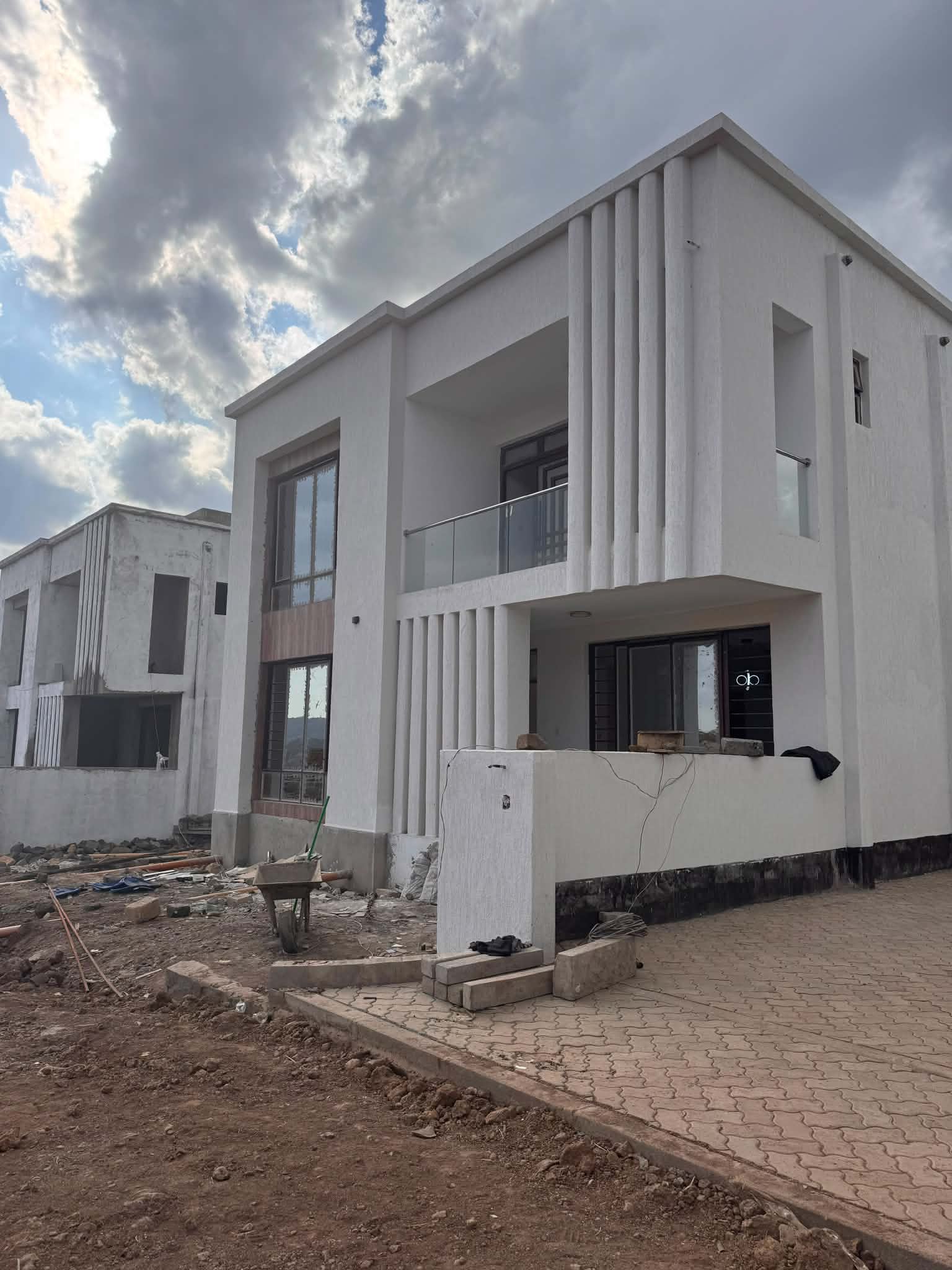 Villa exterior with a covered balcony