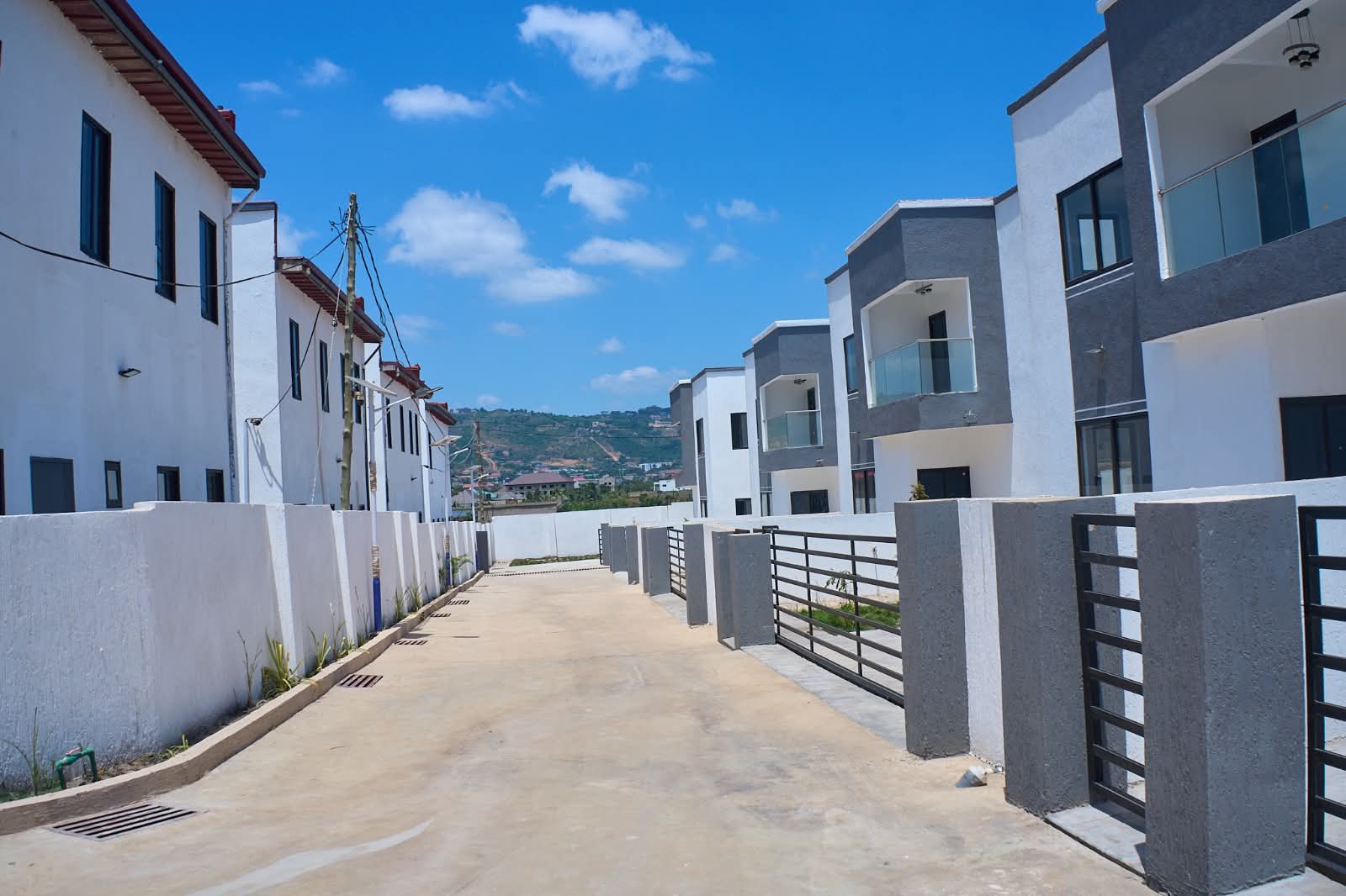Paved street between rows of villas